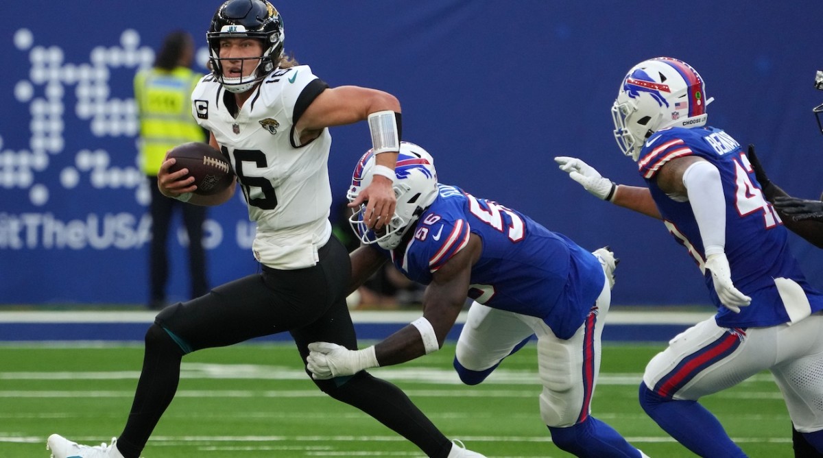 Oct 8, 2023; London, United Kingdom; Jacksonville Jaguars quarterback Trevor Lawrence (16) is pressured by Buffalo Bills defensive end Leonard Floyd (56) and linebacker Terrel Bernard (43) during the second half of an NFL International Series game at Tottenham Hotspur Stadium. Mandatory Credit: Kirby Lee-USA TODAY Sports